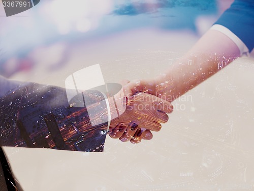 Image of businesswoman and businessman handshake