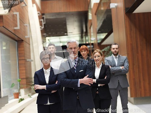 Image of senior business man with his team at office
