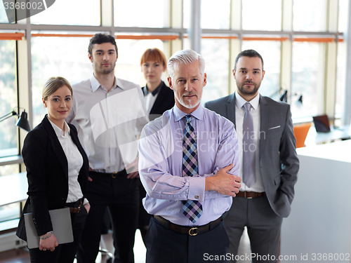 Image of senior business man with his team at office