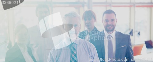 Image of senior business man with his team at office