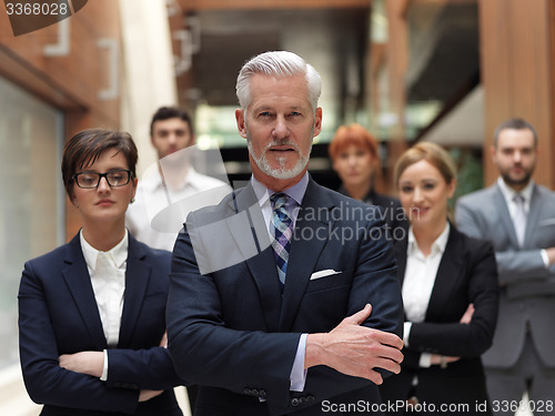 Image of senior business man with his team at office