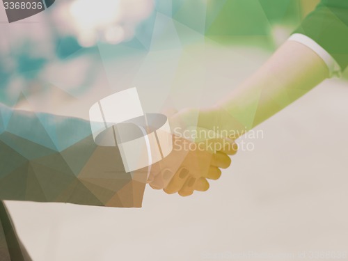 Image of businesswoman and businessman handshake