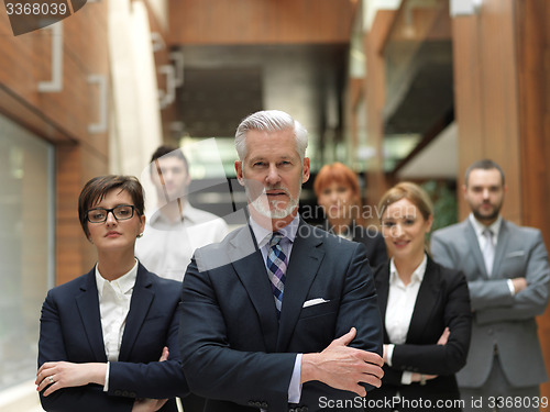 Image of senior business man with his team at office