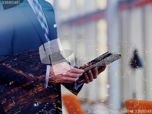 Image of senior business man working on tablet computer