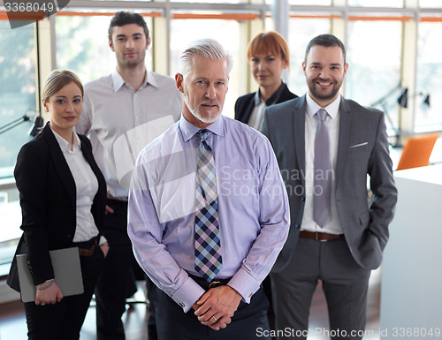 Image of senior business man with his team at office