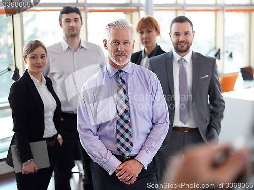 Image of senior business man with his team at office