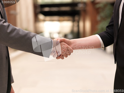 Image of businesswoman and businessman handshake