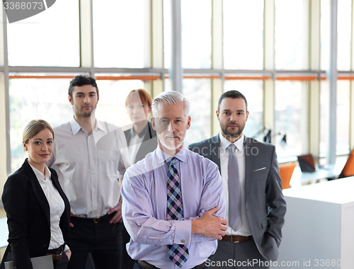 Image of senior business man with his team at office
