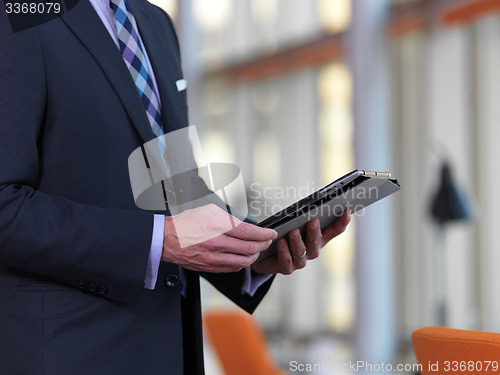 Image of senior business man working on tablet computer