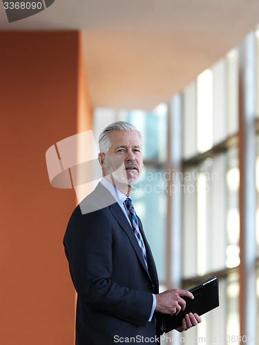 Image of senior business man working on tablet computer