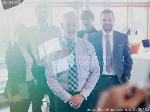 Image of senior business man with his team at office