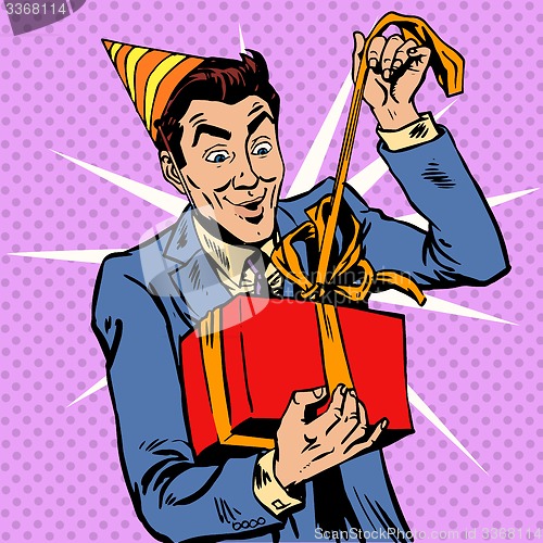 Image of Male birthday unpacks the gift