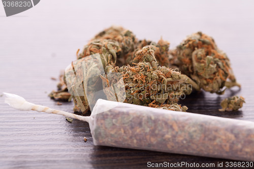 Image of Close up of dried marijuana leaves and joint