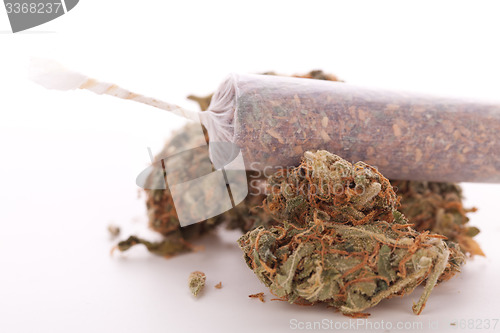 Image of Close up of dried marijuana leaves and joint