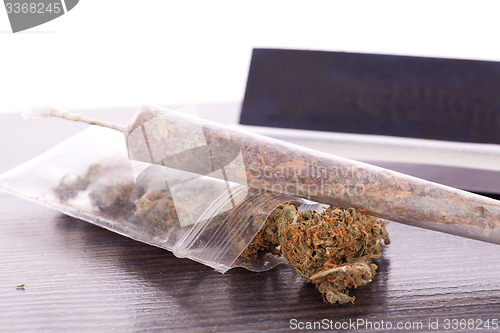 Image of Dried Cannabis on Rolling Paper with Filter