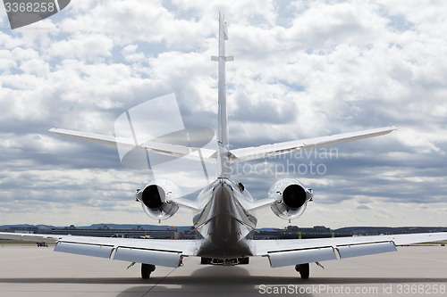 Image of Aircraft learjet Plane in front of the Airport with cloudy sky