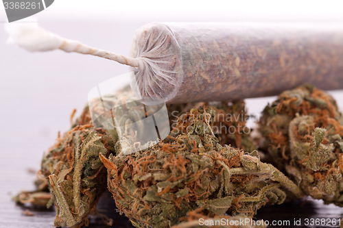 Image of Close up of dried marijuana leaves and joint