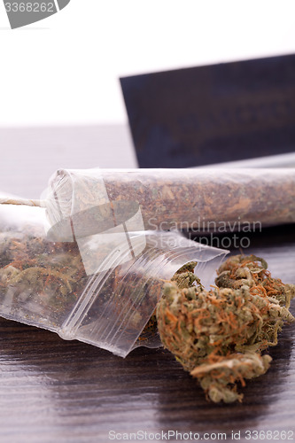 Image of Dried Cannabis on Rolling Paper with Filter