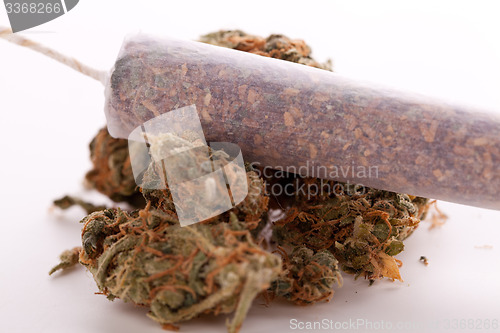 Image of Close up of dried marijuana leaves and joint