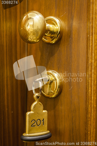 Image of Hotel Room Key lying on Bed with keyring