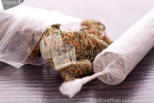 Image of Close up of dried marijuana leaves and joint