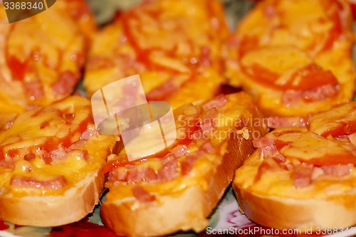 Image of hot sandwiches with sausage and melted cheese