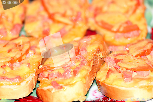 Image of hot sandwiches with sausage and melted cheese