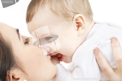 Image of happy mother kissing baby boy