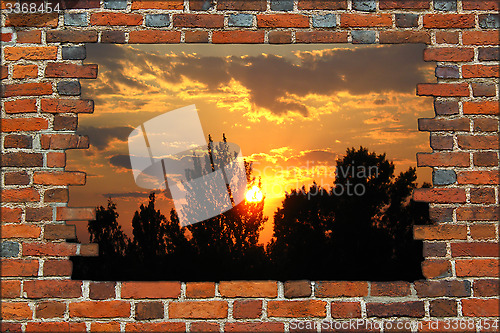 Image of broken brick wall and view to the sunset