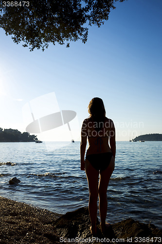 Image of Woman standing on shore