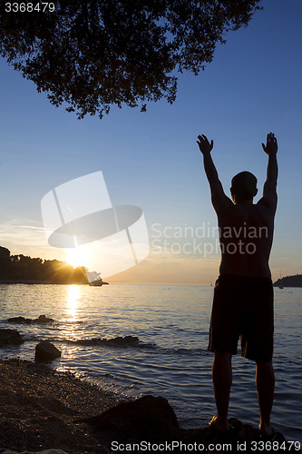 Image of Man standing on shore