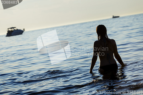 Image of Woman standing in shallow