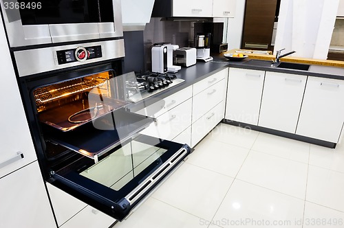 Image of Modern hi-tek kitchen, oven with open door