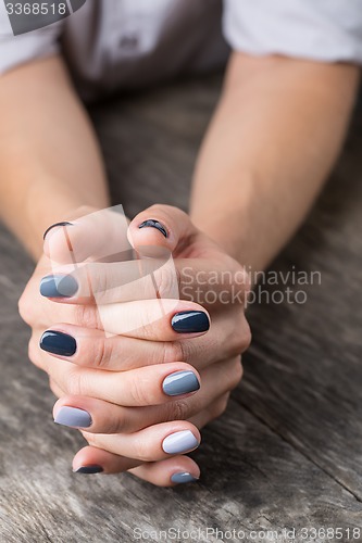 Image of Beautiful hands with the miniature painted in a gray-colored 