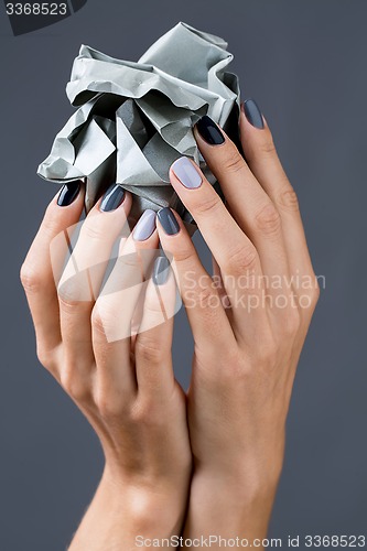 Image of Stylish manicure in shades of gray female elegant handles.