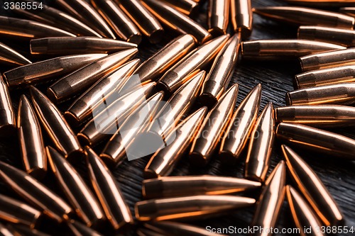 Image of Placer copper bullets on a dark wooden background