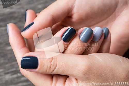 Image of Beautiful hands with the miniature painted in a gray-colored 