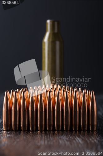 Image of Macro shot of copper bullets that are in many rows to form a tri