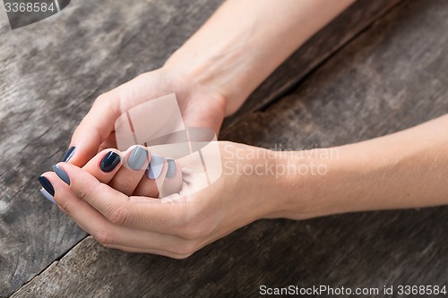 Image of Beautiful hands with the miniature painted in a gray-colored 