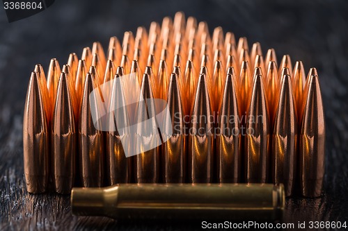 Image of Macro shot of copper bullets that are in many rows to form a tri