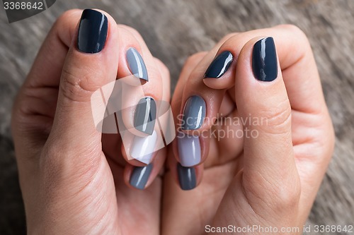 Image of Beautiful hands with the miniature painted in a gray-colored 