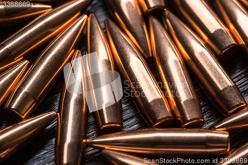 Image of Placer copper bullets on a dark wooden background