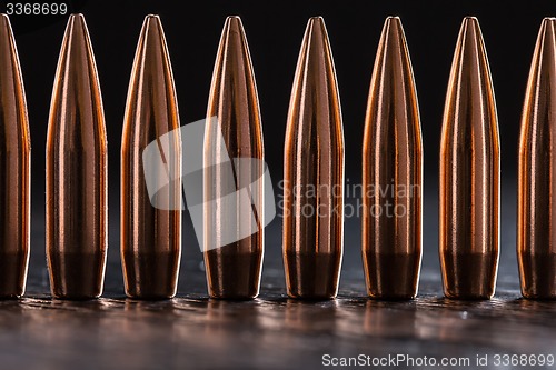 Image of Macro shot of copper bullets that are in one row