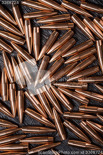 Image of Placer copper bullets on a dark wooden background