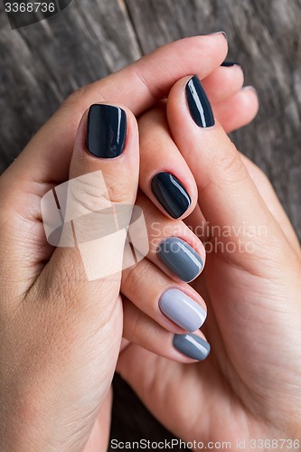 Image of Beautiful hands with the miniature painted in a gray-colored 