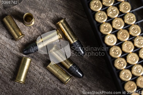 Image of Scattering of small caliber cartridges on a wooden background