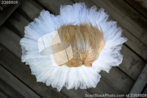 Image of Close portrait of a cute ballerina in white tutu and blue bathin