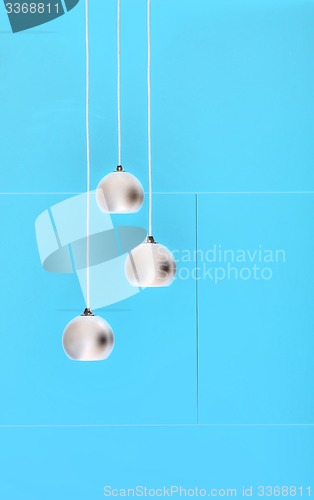 Image of Blue negative collage of three ceiling lights, loft-style interi