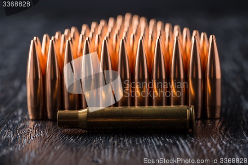 Image of Macro shot of copper bullets that are in many rows to form a tri