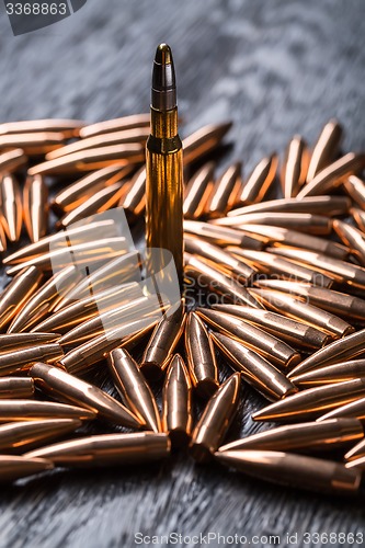 Image of Placer copper bullets on a dark wooden background